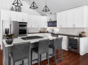 Modern kitchen with gray and white accents against a darkly colored hardwood floor