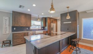 Beautifully remodeled kitchen with a stunning kitchen bar and naturally colored cabinetry