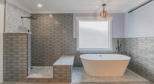 Beautiful bathroom remodel with stone walls and a deep tub
